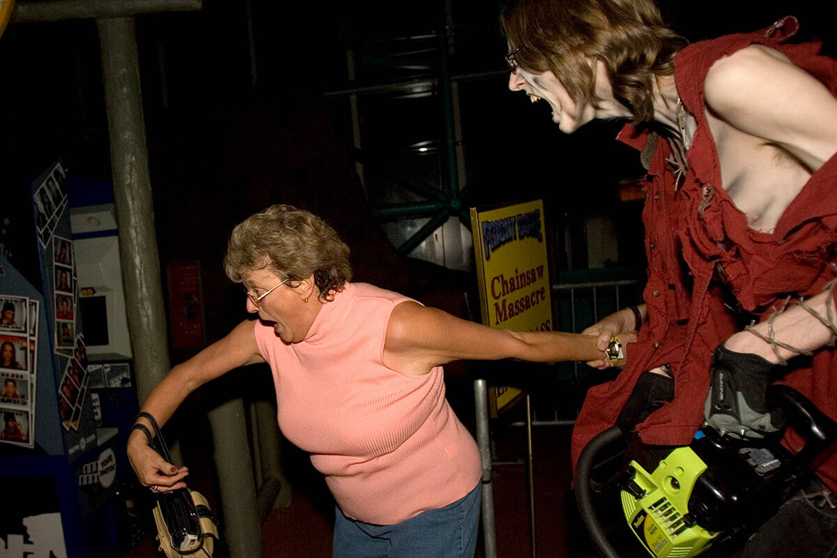 Jan Bingham runs from a chain saw-wielding monster in the Fright Dome at Circus Circus on Thurs ...