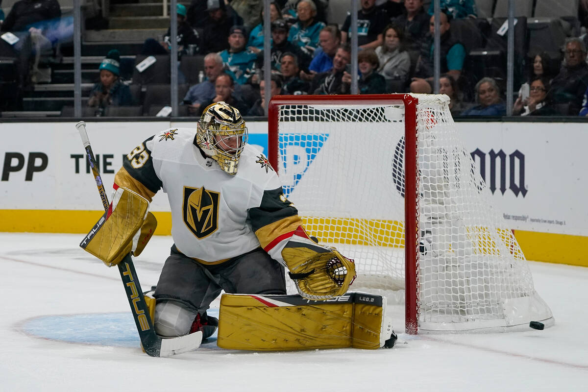 Vegas Golden Knights goaltender Adin Hill (33) deflects a shot against the San Jose Sharks duri ...