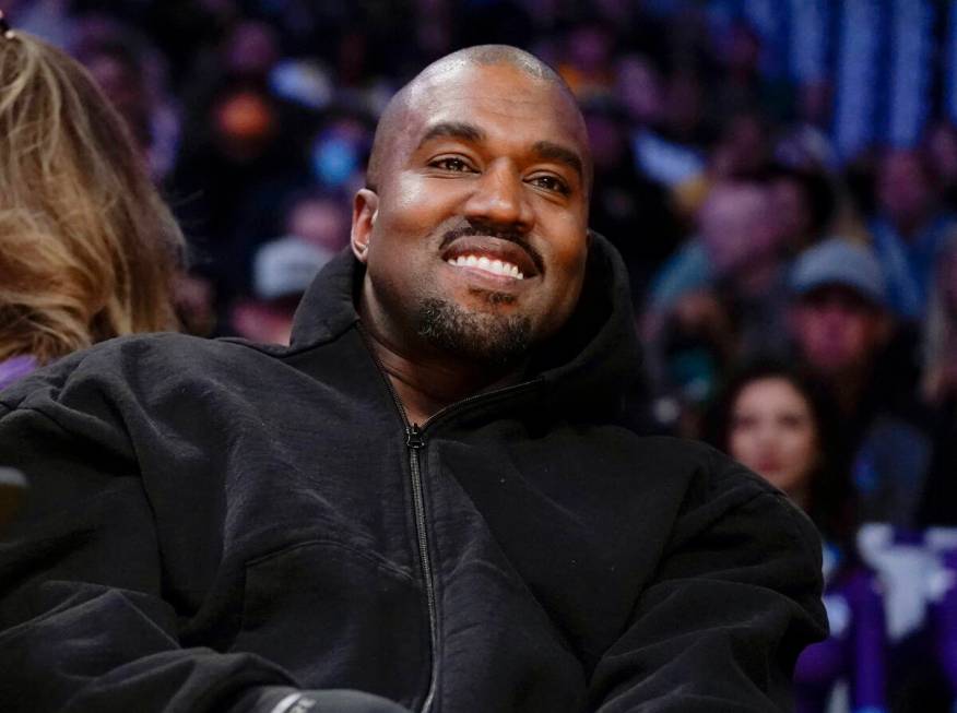Kanye West watches the first half of an NBA basketball game between the Washington Wizards and ...