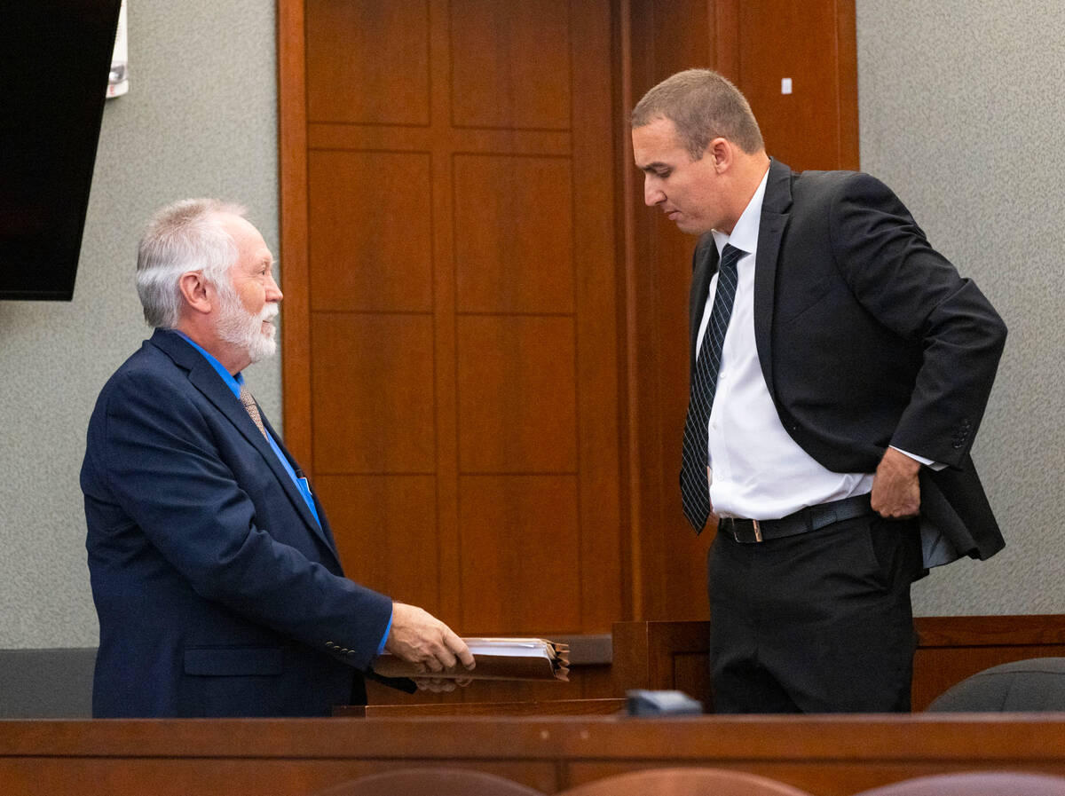 Edward Kane, left, Robert Telles' former public defender, hands over documents to Telles' priva ...