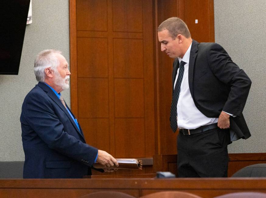 Edward Kane, left, Robert Telles' former public defender, hands over documents to Telles' priva ...