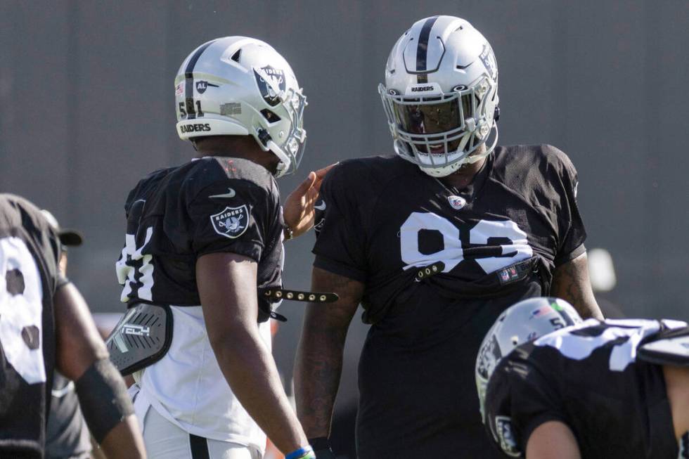 Raiders defensive end Malcolm Koonce (51) and defensive tackle Neil Farrell Jr. (93) meet on th ...