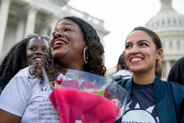 Rep. Cori Bush, D-Mo., and Rep. Alexandria Ocasio-Cortez, D-N.Y., smile after it was annou ...