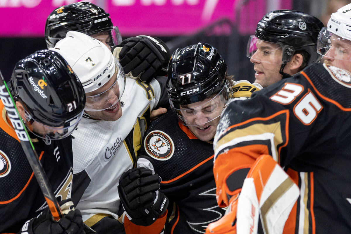 Players break up a fight between Golden Knights defenseman Alex Pietrangelo (7) and Ducks right ...