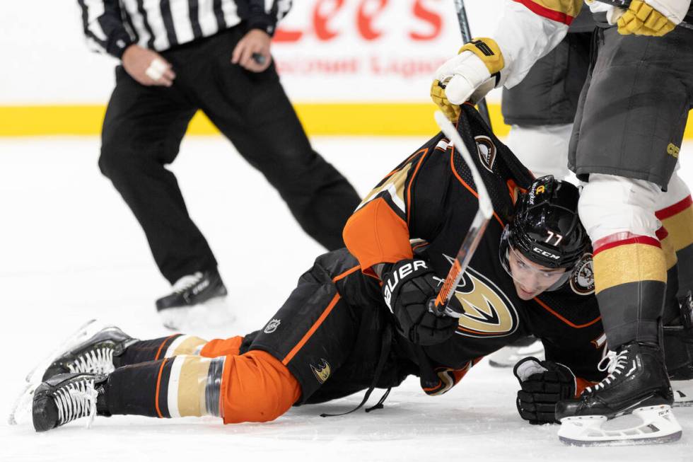 Golden Knights center Jake Leschyshyn (15) pulls Ducks right wing Frank Vatrano (77) away from ...