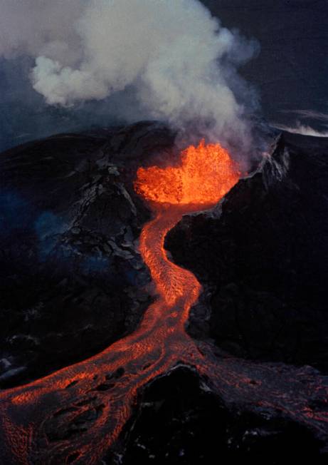 FILE - Lava flows downhill from the crater of Mauna Loa, April 5, 1984, on the island of Hawaii ...