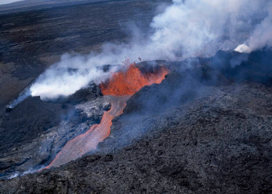 FILE - Molten rock flows from Mauna Loa, located on the south-central part of the island of Haw ...