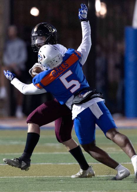 Bishop Gorman’s Jeremiah Vessel (5) tackles Faith Lutheran’s Rylan Walter (13) du ...