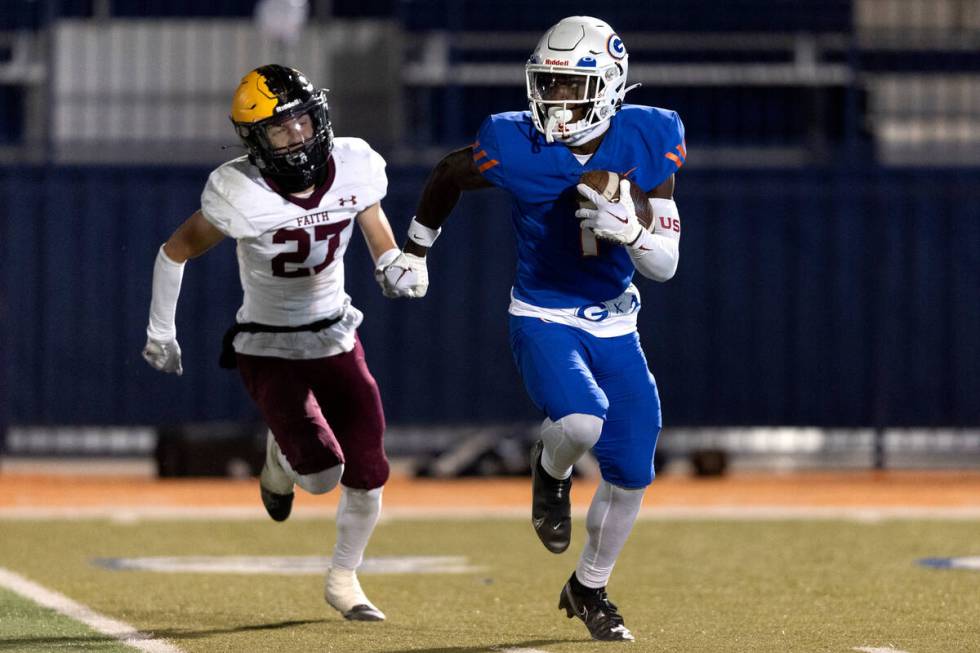 Bishop Gorman’s Zachariah Branch (1) breaks away with the ball before scoring a touchdow ...