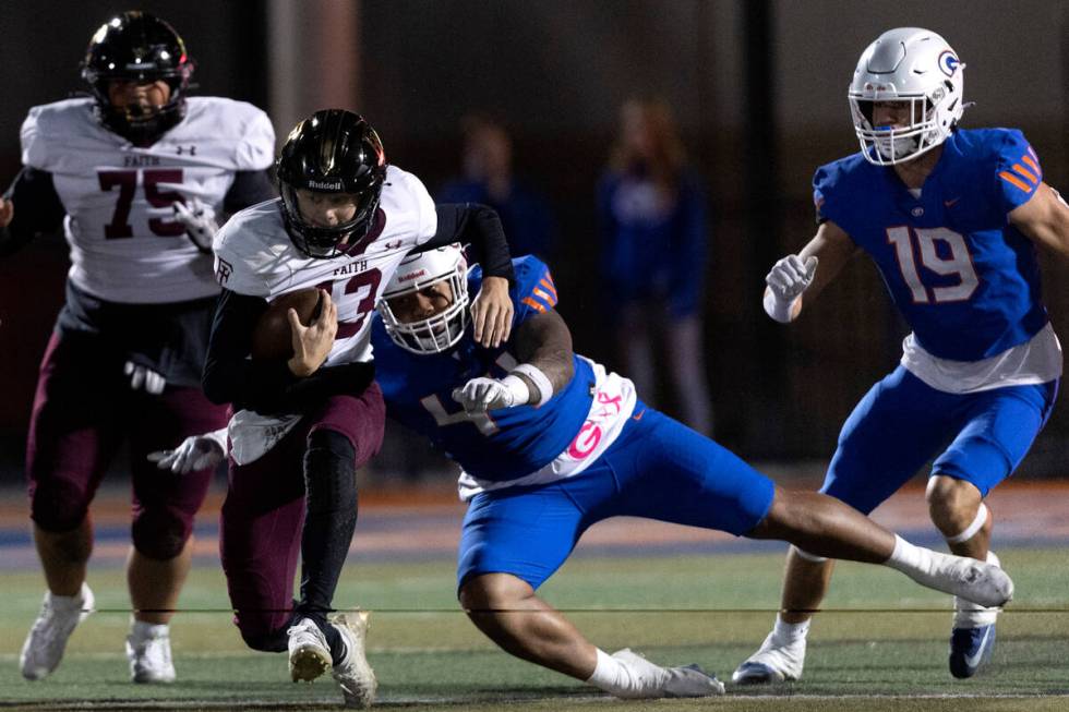 Bishop Gorman’s Aiden McComber (44) tackles Faith Lutheran’s Rylan Walter (13) du ...