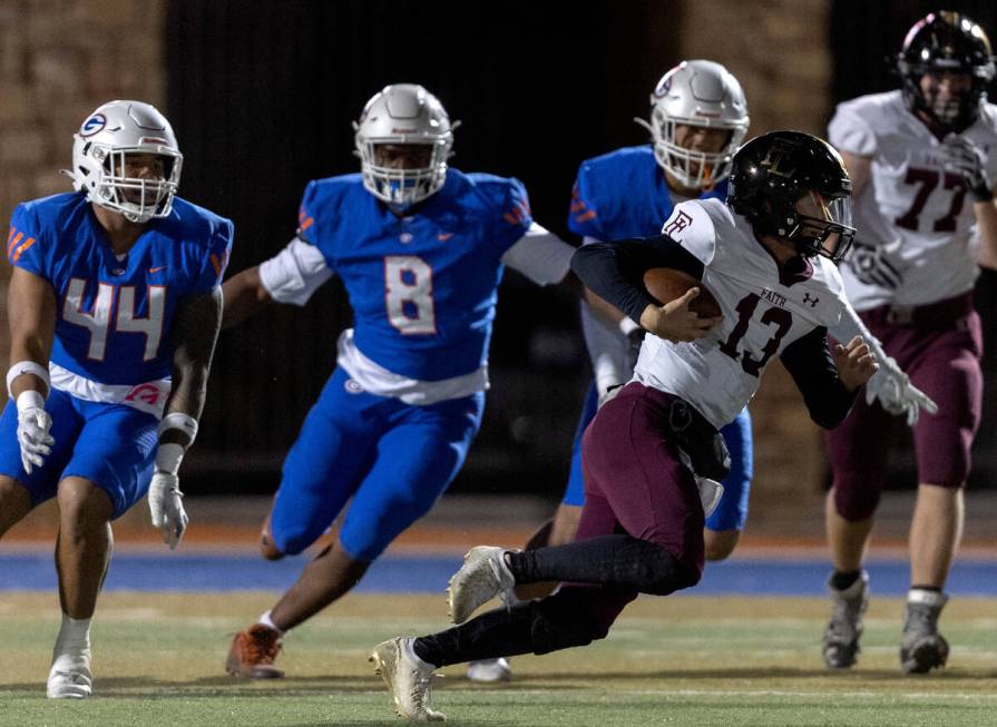 Faith Lutheran’s Rylan Walter (13) runs the ball followed by Bishop Gorman’s defe ...