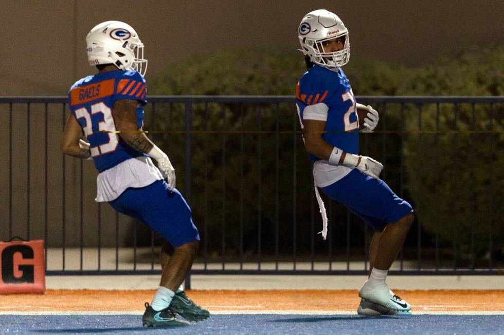 Bishop Gorman’s Micah Kaapana (22) makes it to the end zone for a touchdown followed by ...