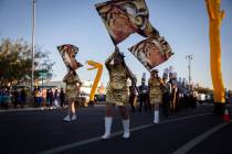 Bonanza High School cheerleaders and marching band members walk in a parade celebrating the Bol ...