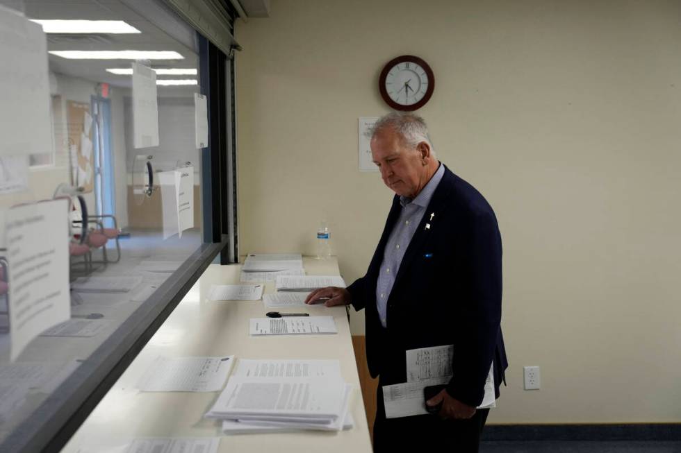 Interim Nye County Clerk Mark Kampf works in an office where early votes are being counted Wedn ...