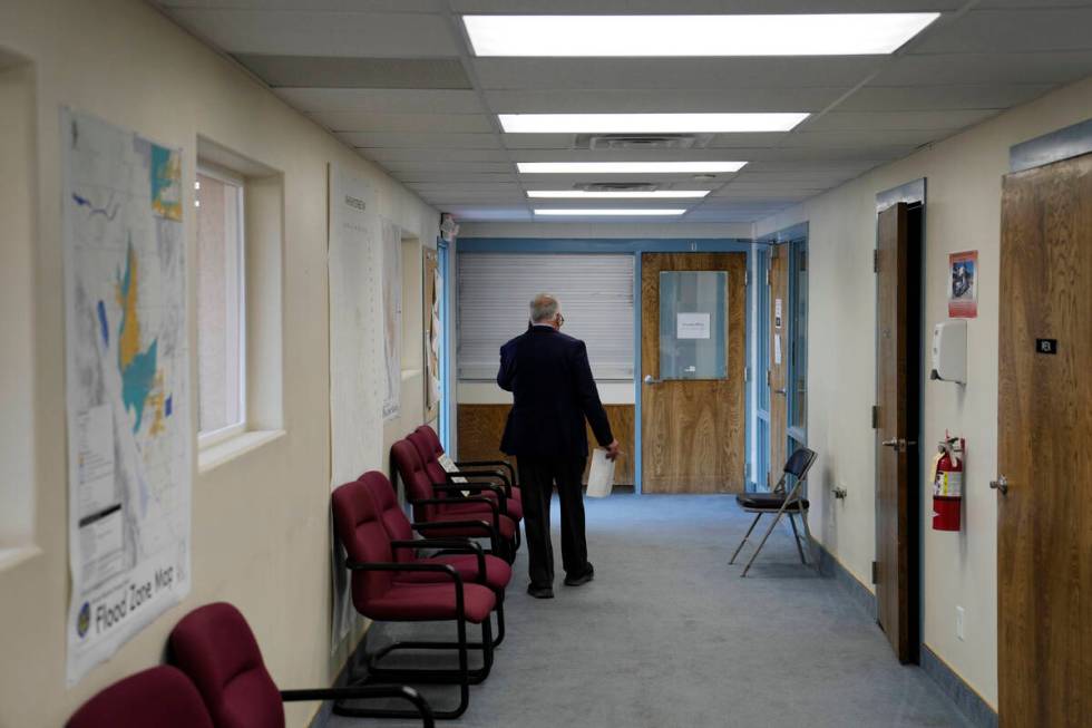 Interim Nye County Clerk Mark Kampf walks down a hallway at an office where early votes are bei ...