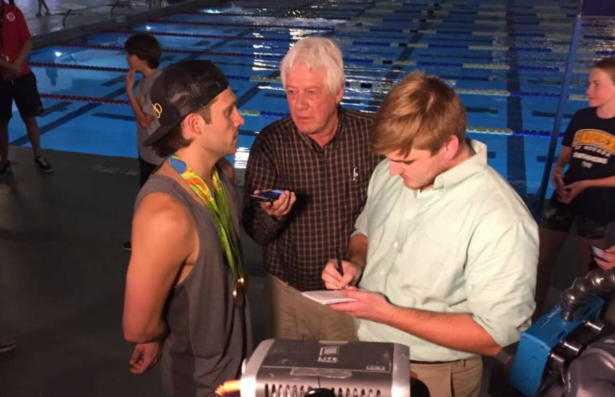 Keith Rogers, center, interviews Las Vegas native and 2016 Olympic champion Cody Miller at his ...