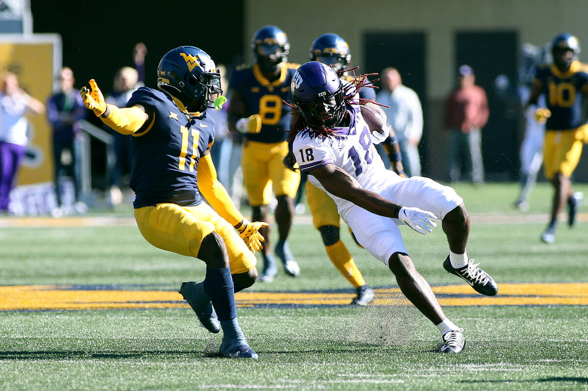 TCU wide receiver Savion Williams (18) tries to avoid West Virginia cornerback Wesley McCormick ...