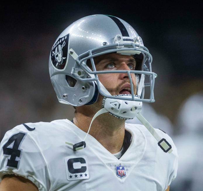 Raiders quarterback Derek Carr (4) watches the replay screen versus the New Orleans Saints duri ...