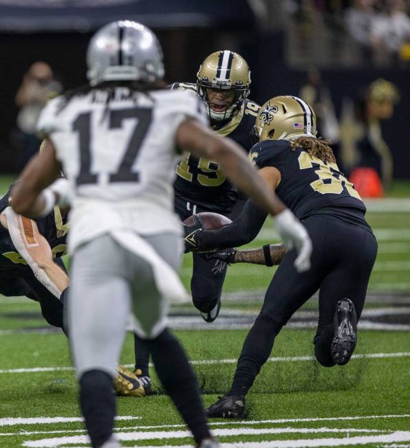 New Orleans Saints safety Tyrann Mathieu (32) intercepts a pass with safety Chris Harris Jr. (1 ...