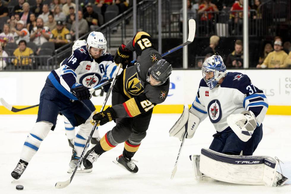 Winnipeg Jets defenseman Josh Morrissey (44) crosschecks Vegas Golden Knights center Brett Howd ...