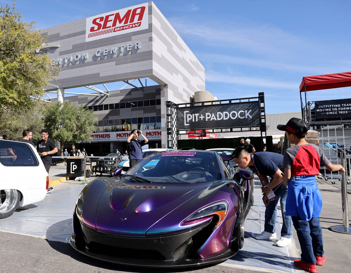 Andy Nguyen and his son Gavin, 12, of Atlanta check out a 2015 Mclaren P1 ahead of the Specialt ...