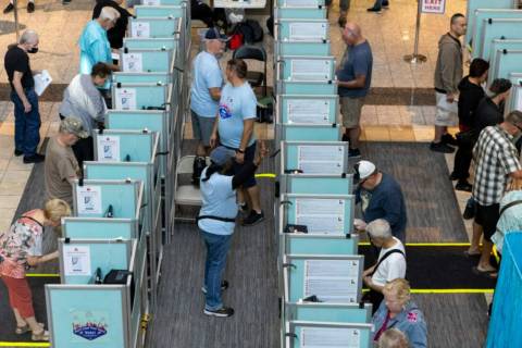 People cast their votes at the polling place inside of the Galleria At Sunset shopping mall in ...