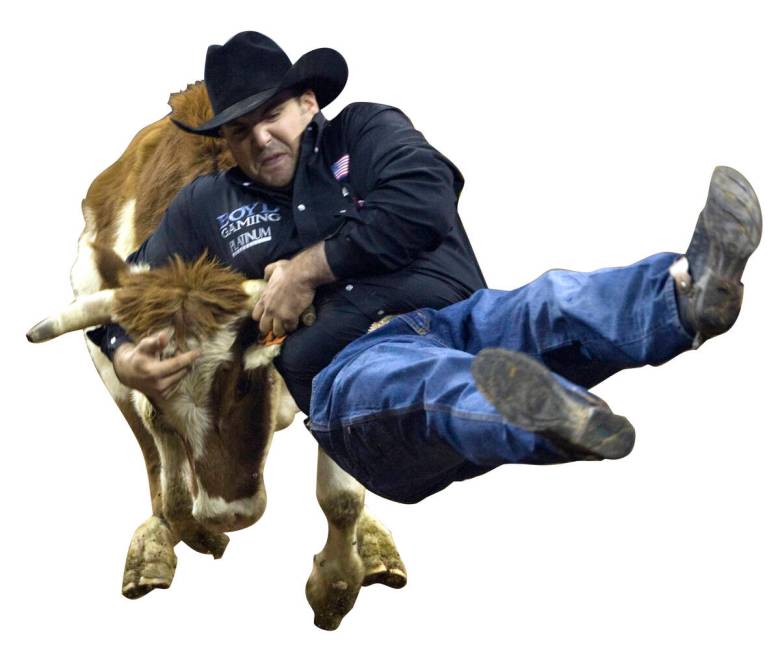 Luke Branquinho of Los Alamos, Calif., wrestles a steer in a time of 3.5 seconds to win the six ...