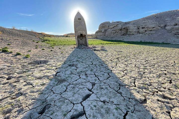 A long-submerged boat, exposed by drought at Lake Mead, stands as a monument to the transformin ...