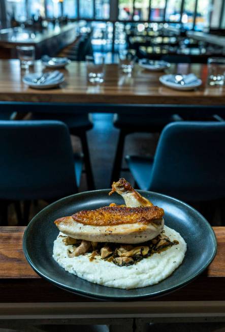 A portion of oven roasted chicken, braised greens and smoked polenta from Main St. Provisions o ...