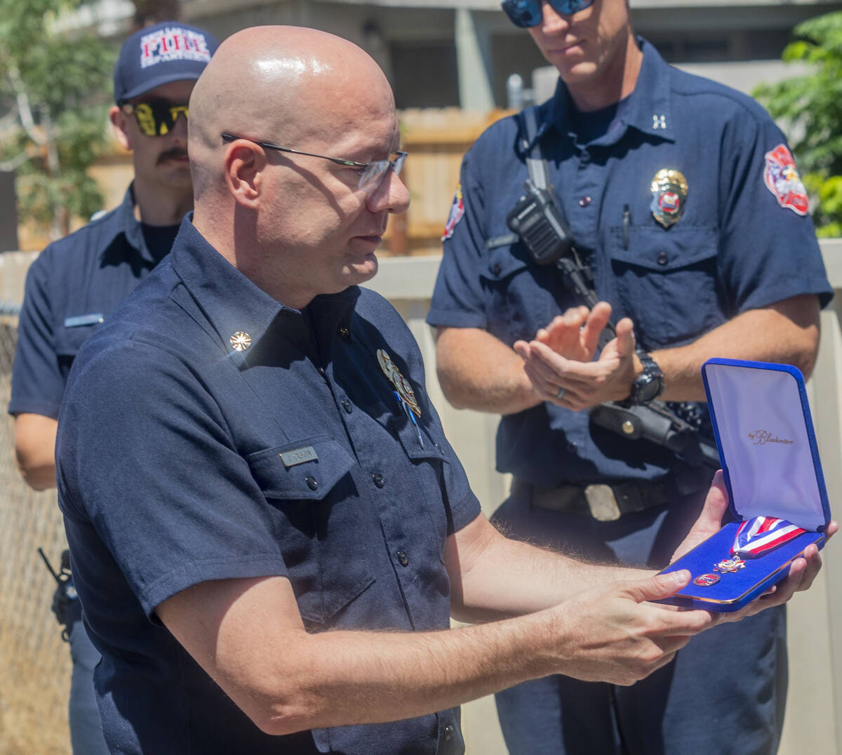 North Las Vegas Fire Chief Joseph Calhoun presents a medal of honor to civilian Jose Alvarado o ...