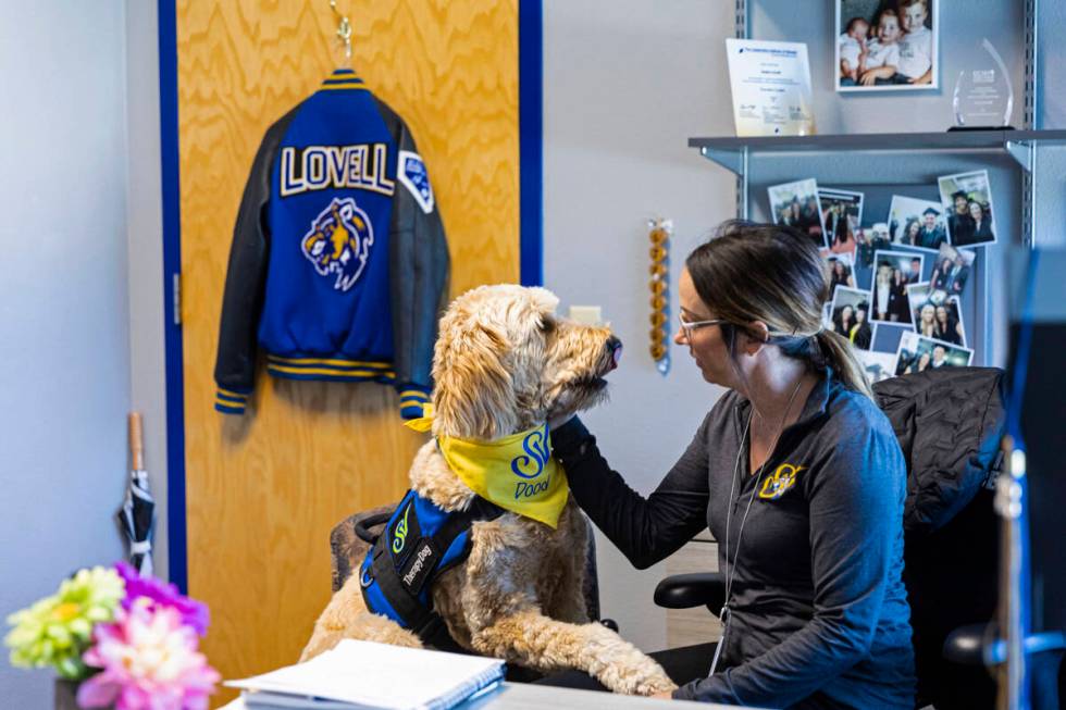 Sierra Vista High School Principal Jessica Lovell talks with Dood, a Goldendoodle therapy dog w ...