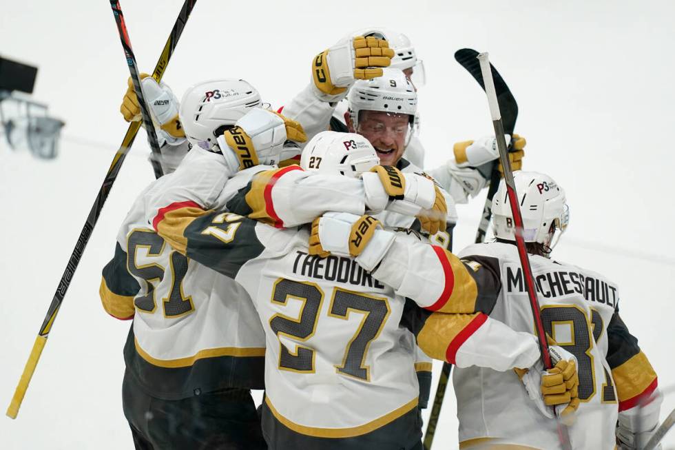 Vegas Golden Knights' Shea Theodore (27) celebrates his goal with teammates during overtime in ...