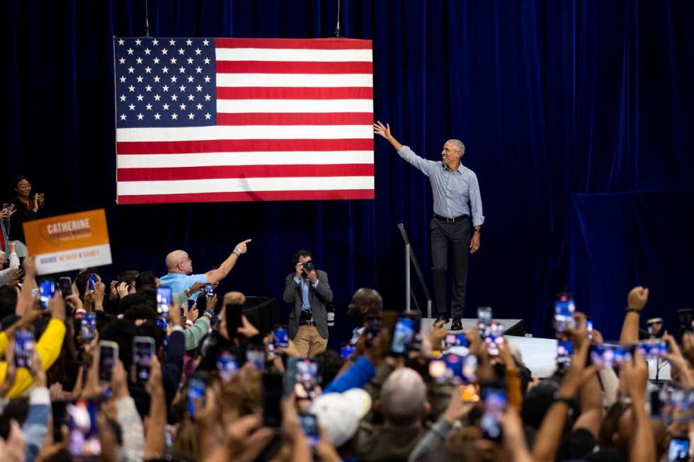 Former President Barack Obama, center, takes the stage during a campaign rally organized by Nev ...