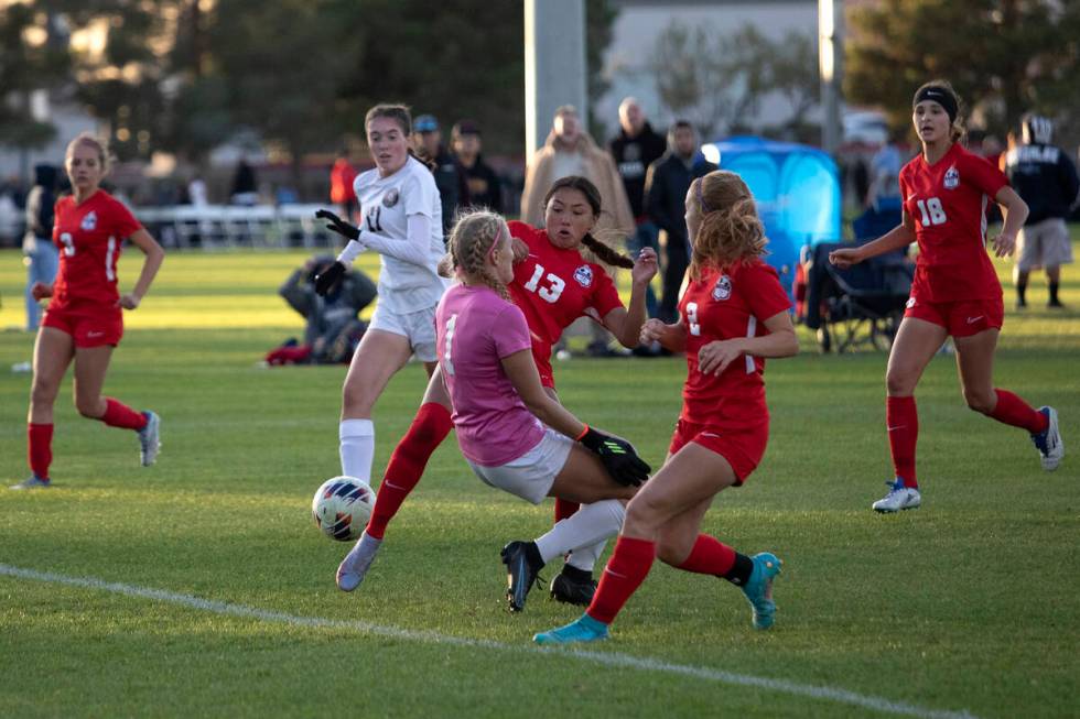 Coronado’s Asia Moises (13) and Elle Bachhuber (2) attempt to score a goal past Desert O ...