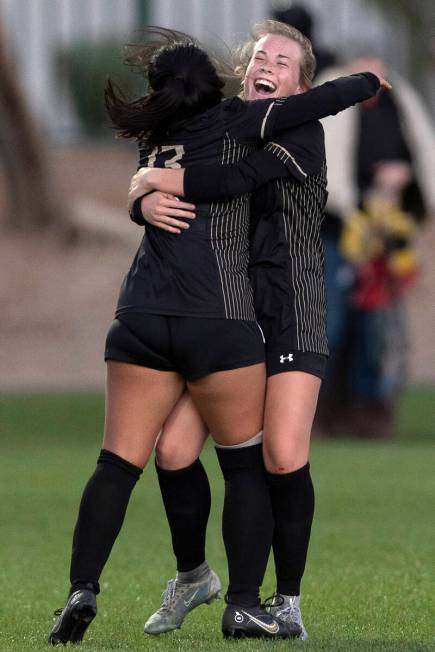 Faith Lutheran’s Mia Coe (13) and Lana Linares (5) celebrate after winning a Class 5A gi ...
