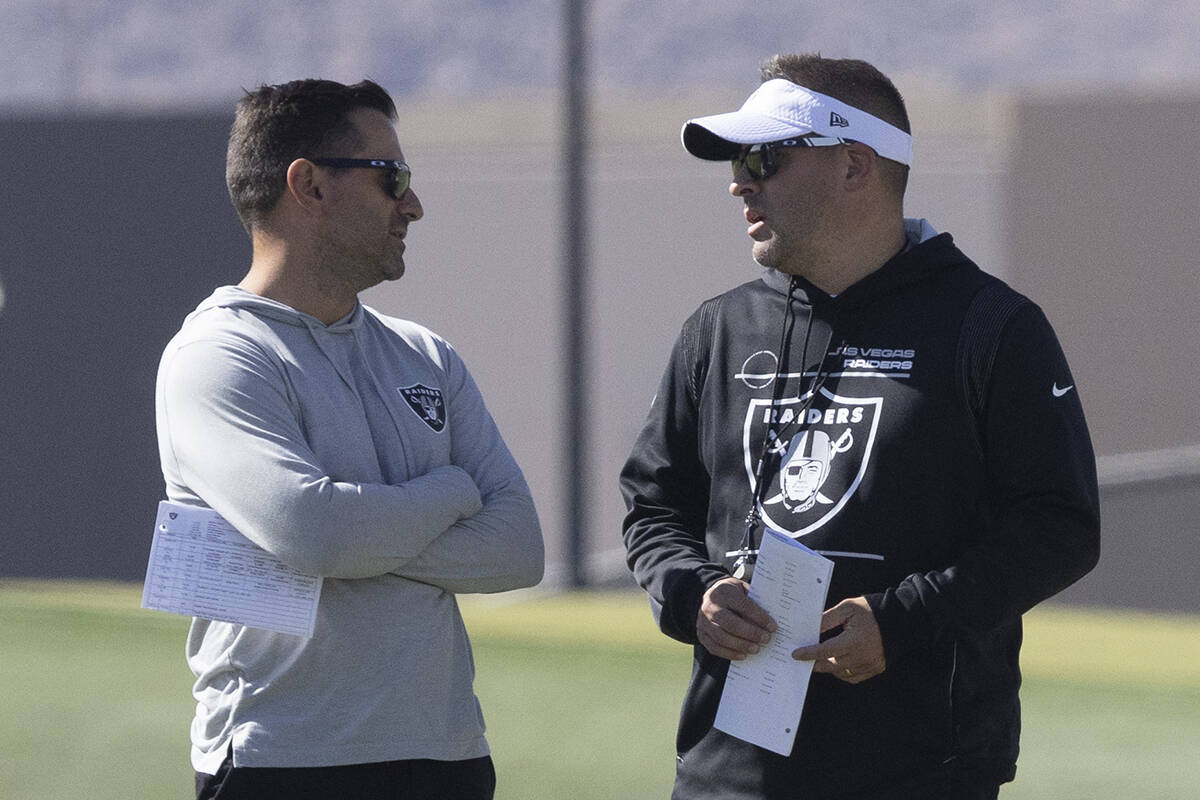 Raiders general manager Dave Ziegler, left, and head coach Josh McDaniels meet during practice ...