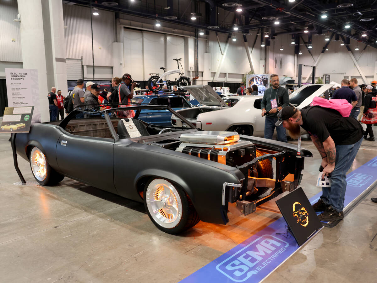 Mark Pagel of Oshkosh, Wis. checks out an all electric Mercury Cougar in the SEMA Electrified s ...