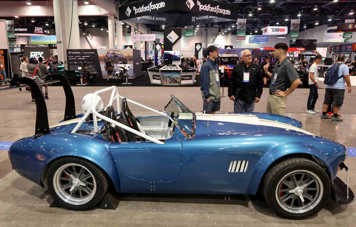 Chris Jimenez of Scorpion EV in Temecula, Calf., right, shows an all electric AC Cobra based on ...