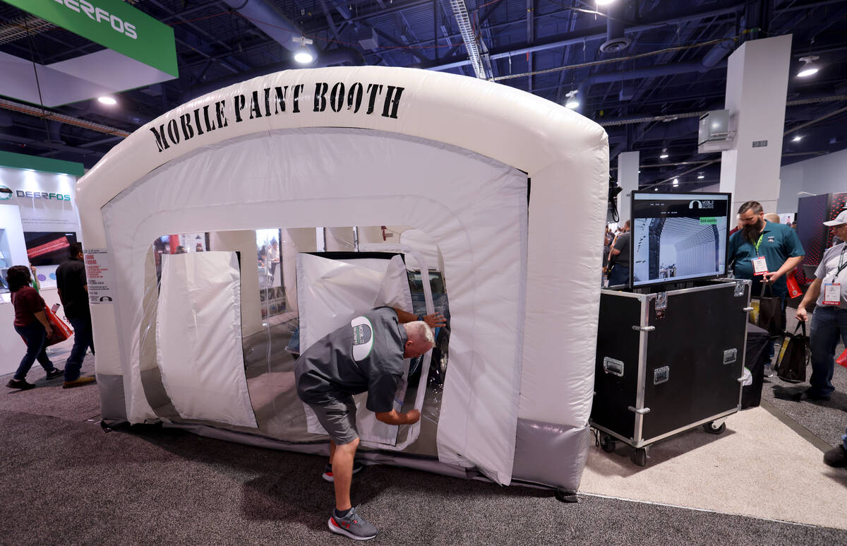 T.J. White of Mobile Environmental Solutions shows a mobile paint booth on Day 2 of the Special ...
