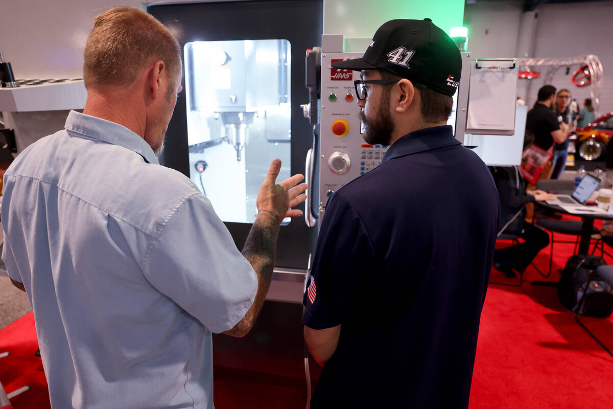 Alfredo Fierros of Haas Automation in Oxnard, Calif., right, shows a machine tool to Thom Ophof ...