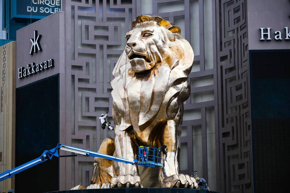 Workers buff the MGM lion statue outside the MGM Grand on Tuesday, April 27, 2021, in Las Vegas ...