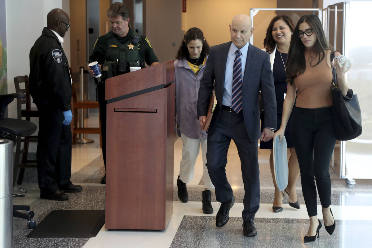 Assistant State Attorney Mike Satz, center, walks into court along with family members of the v ...