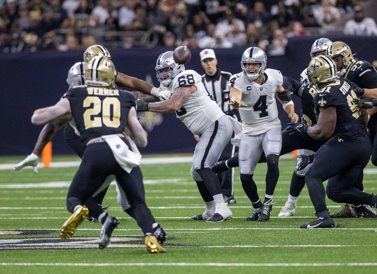 Raiders quarterback Derek Carr (4) throws under pressure from the New Orleans Saints defense du ...
