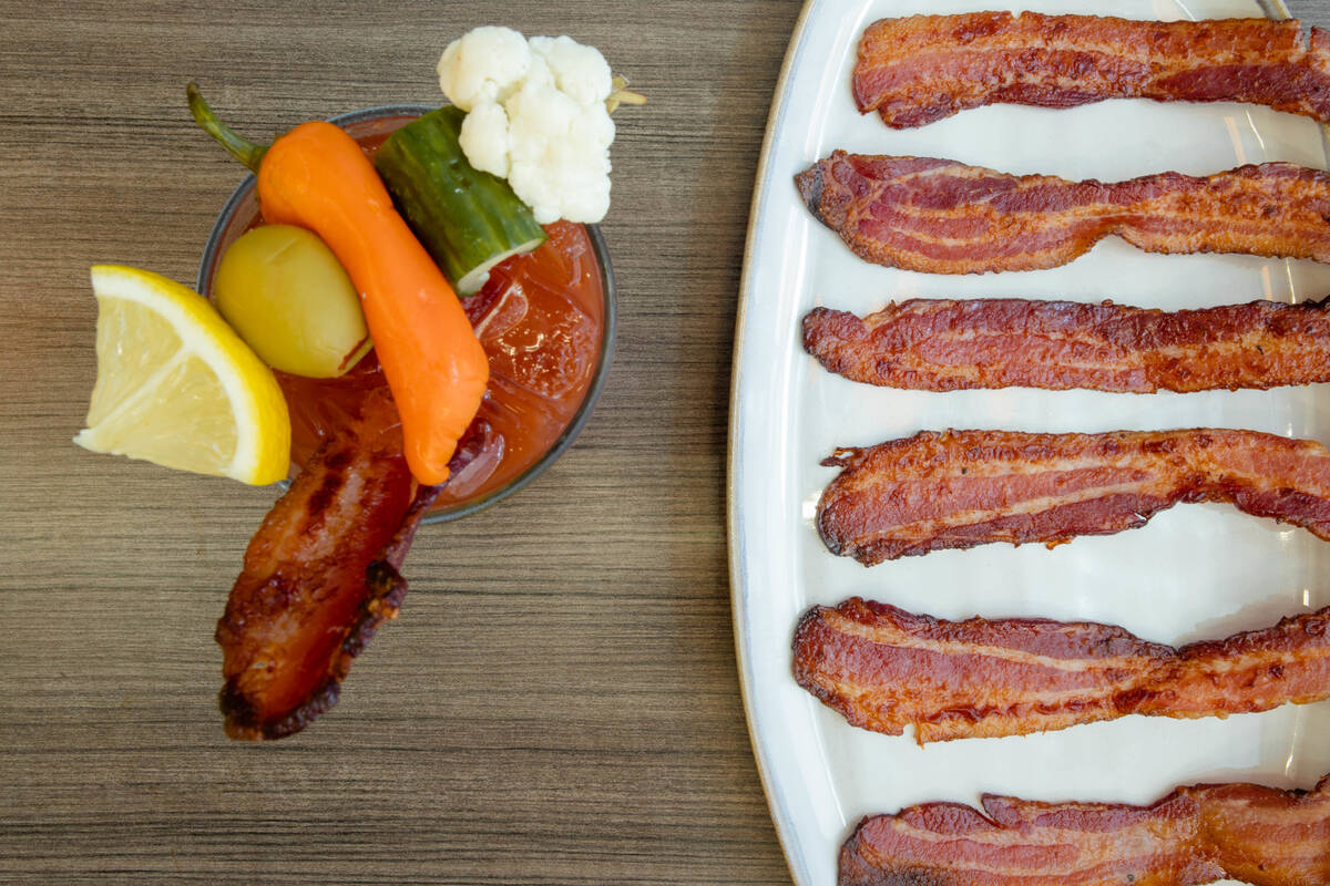 A bacon bloody mary and strips of, well, bacon, from Snooze A.M. Eatery, which is opening its f ...