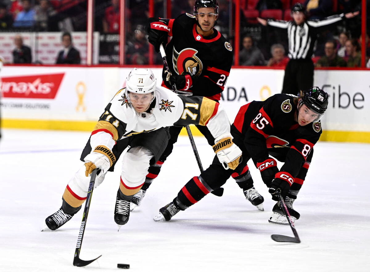 Vegas Golden Knights center William Karlsson (71) stretches out to regain control of the puck a ...