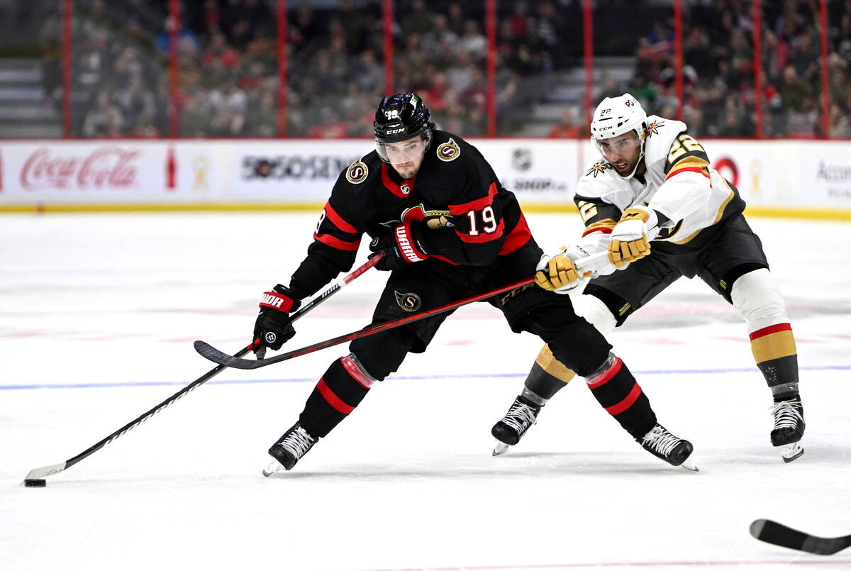 Vegas Golden Knights center Michael Amadio (22) tries to get the puck from Ottawa Senators righ ...