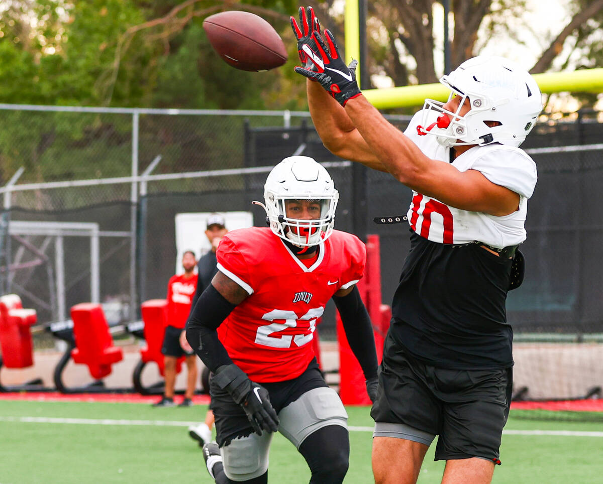 UNLV wide receiver Nick Williams makes the catch under pressure from defensive back Jerrae Will ...