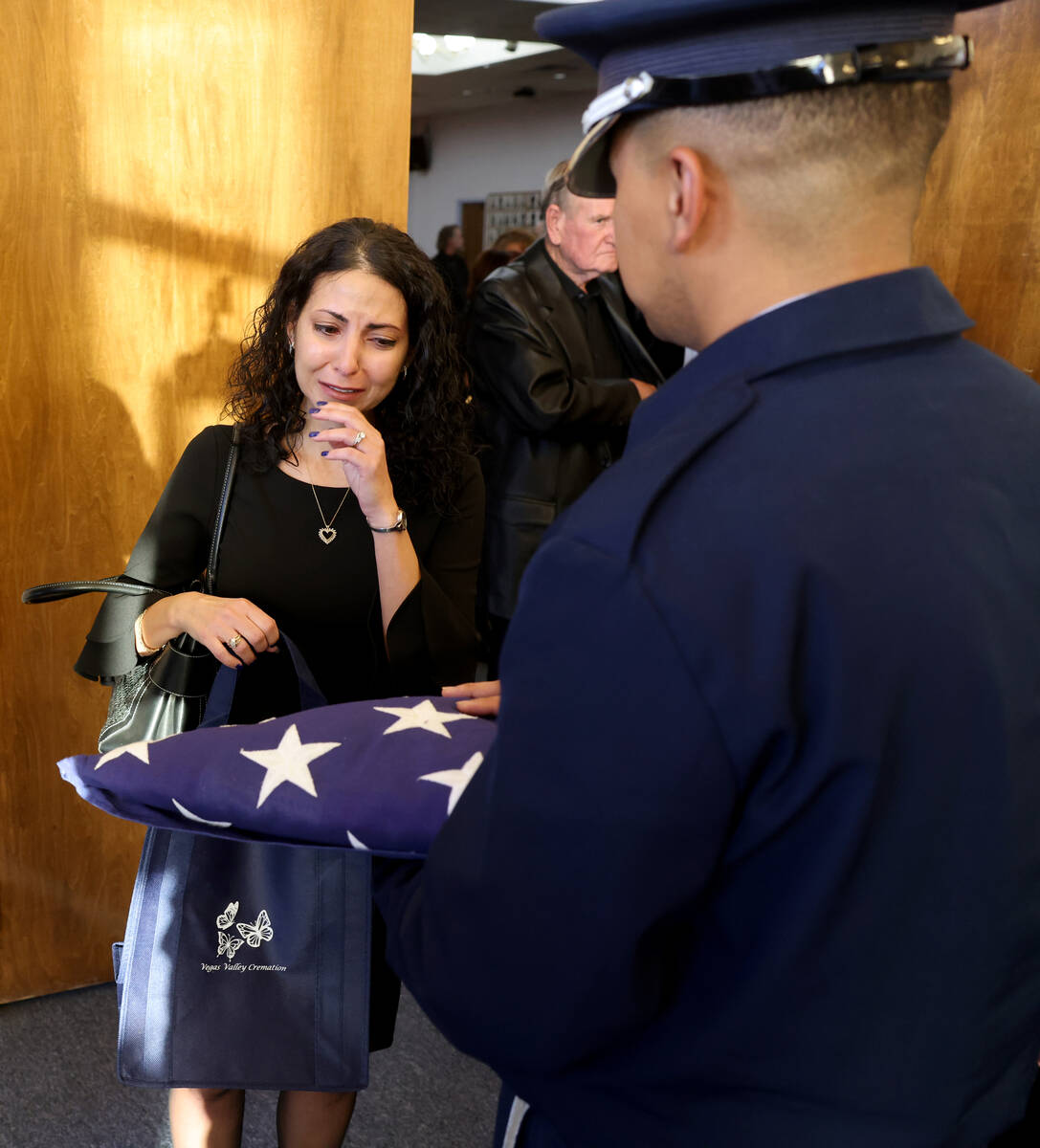Lorraine Mannarino, who was like a daughter to Ed Hall, reacts to his flag during a memorial se ...