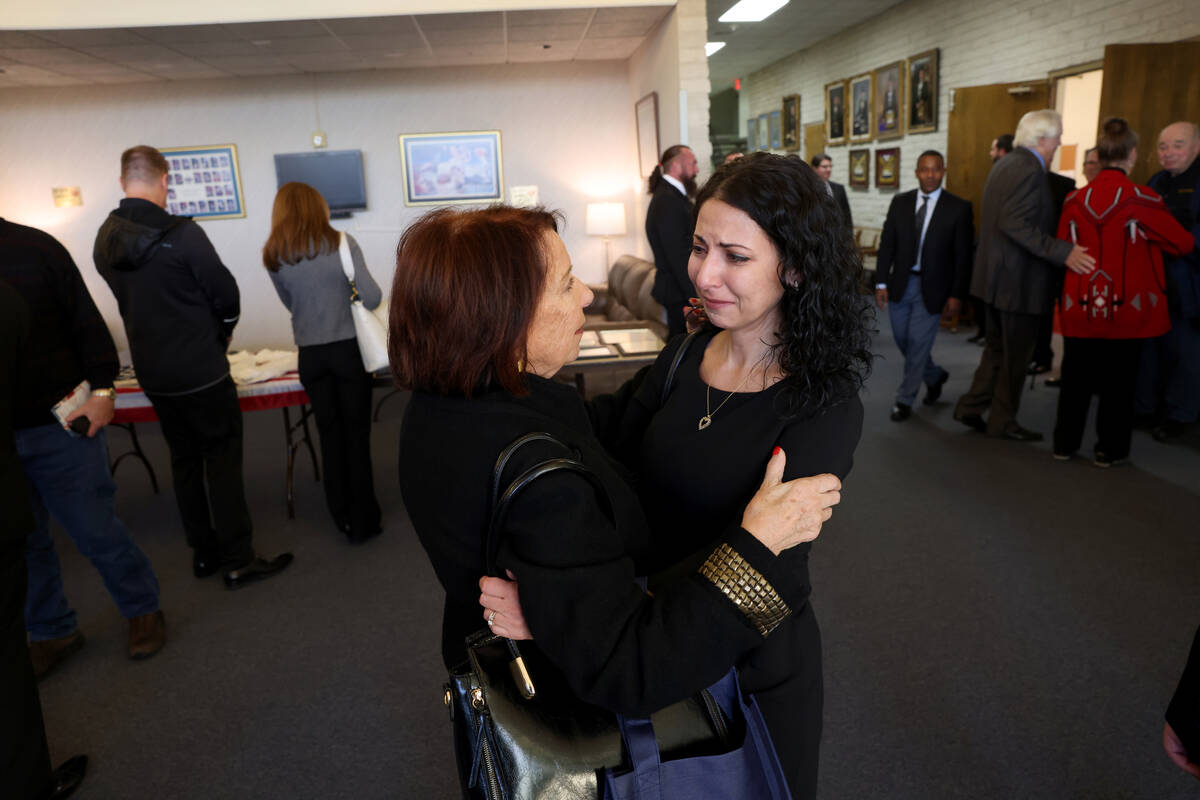 Lorraine Mannarino, right, who was like a daughter to Ed Hall, receives a hug during a memorial ...