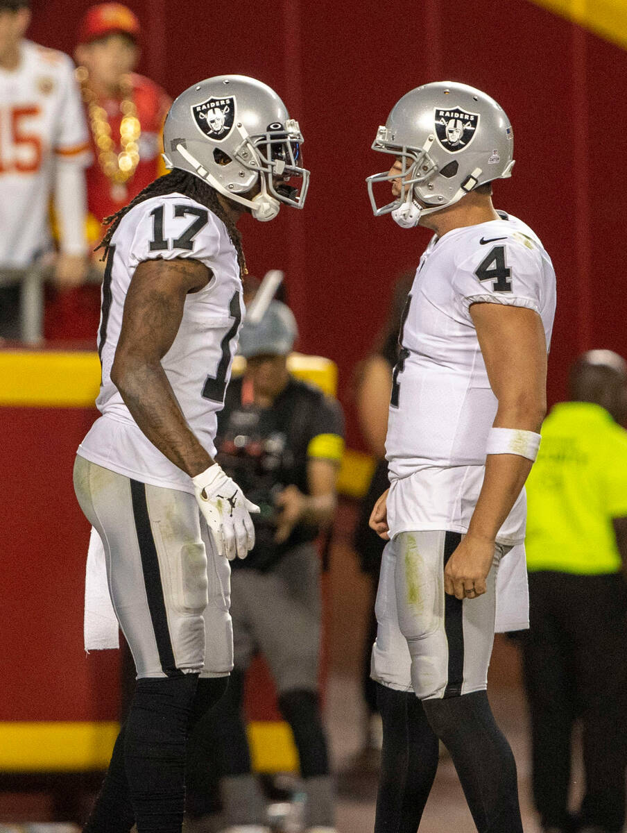 Raiders wide receiver Davante Adams (17) is congratulated by quarterback Derek Carr (4) after s ...